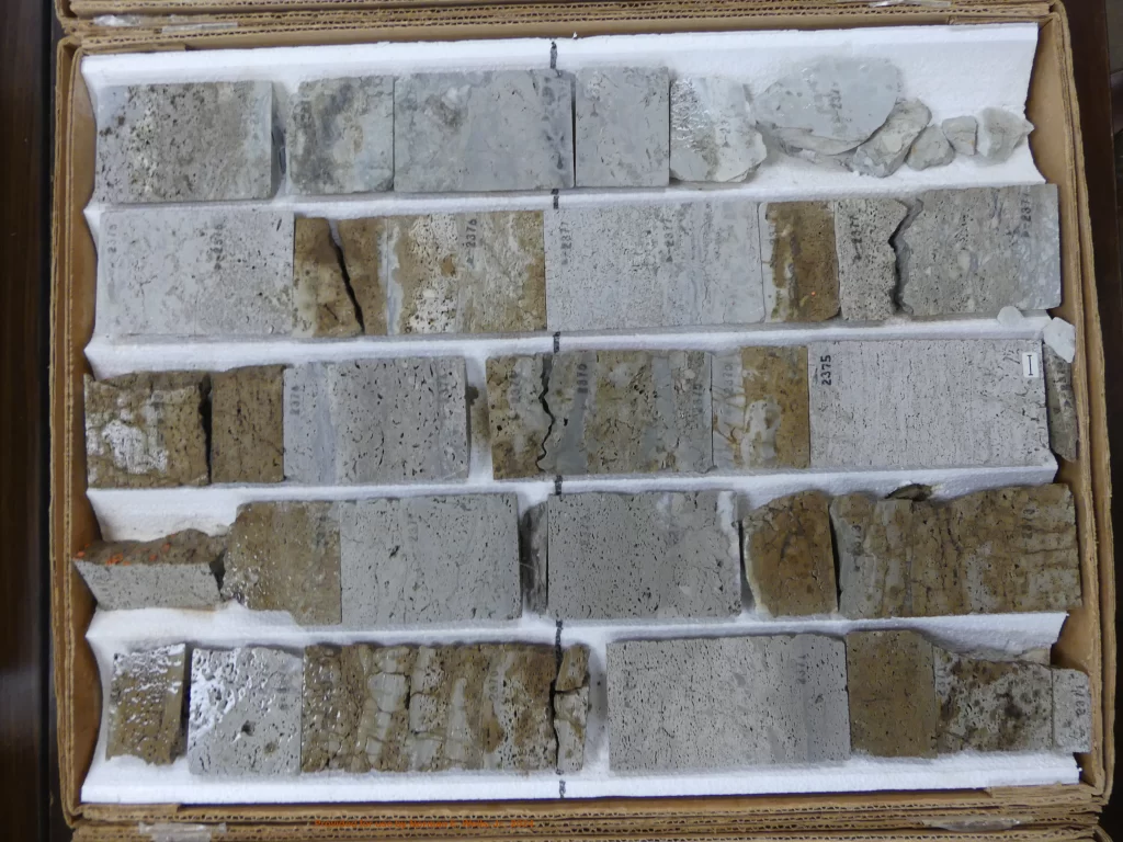 Selection of rock core samples in a box, used for geological analysis in the well permitting process, illustrating the geological investigations required for underground injection and disposal wells.